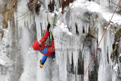 A man climbs up an artificial ice wall in Liberec. 