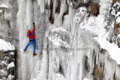 A man climbs up an artificial ice wall in Liberec. 